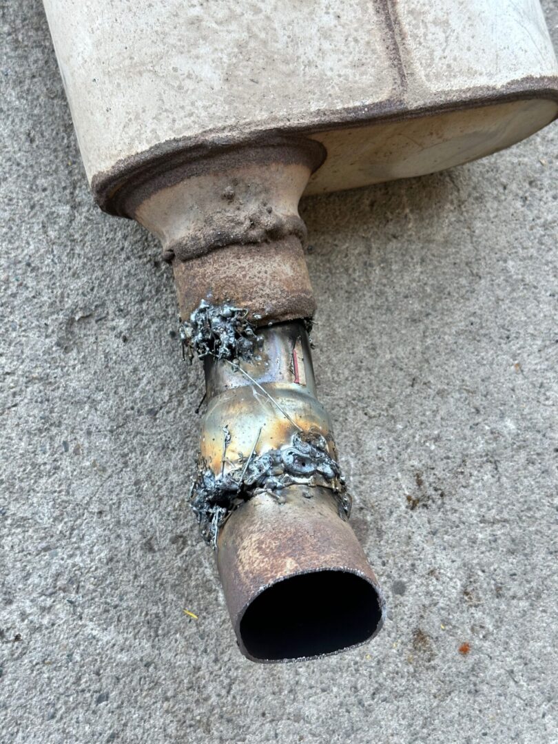 A rusty pipe with chains on it
