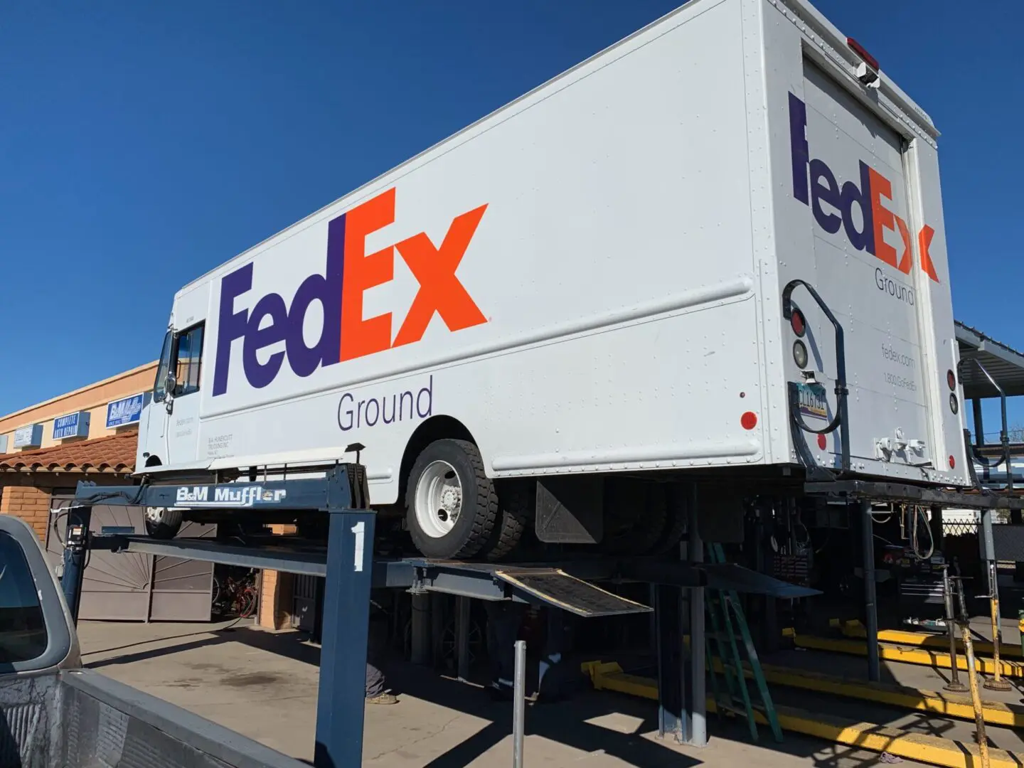 A fedex truck parked on the side of a road.